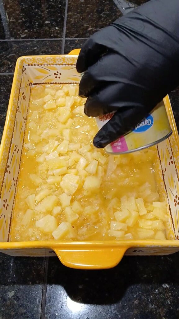 pour pineapple tidbits into pan