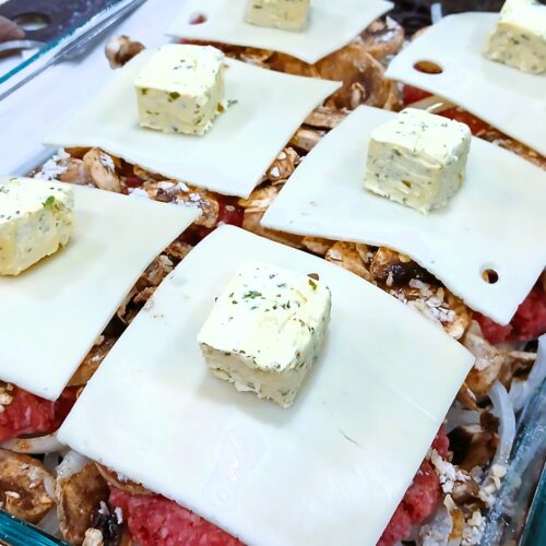 Add swiss cheese and herb butter to burgers